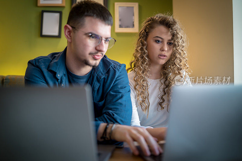 Business people working together at a café using their laptops